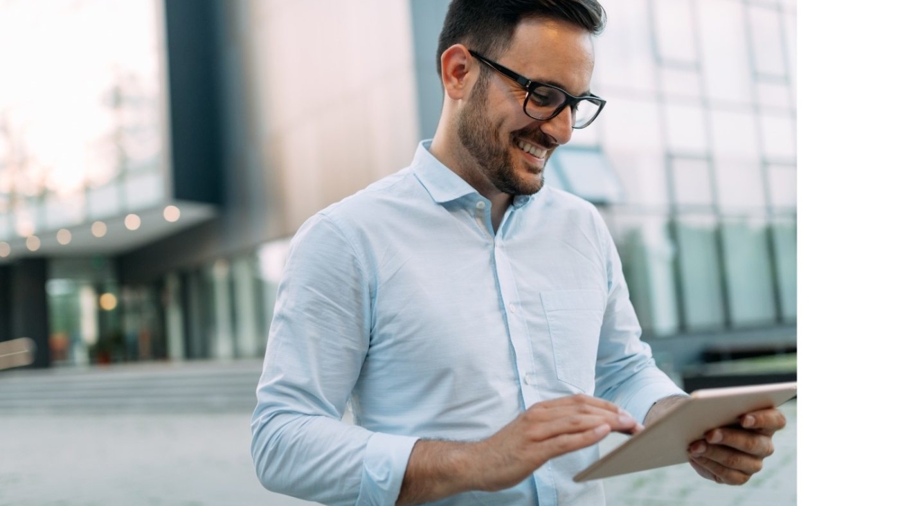 demo-attachment-815-portrait-of-businessman-in-glasses-holding-tablet-AWVHCJU